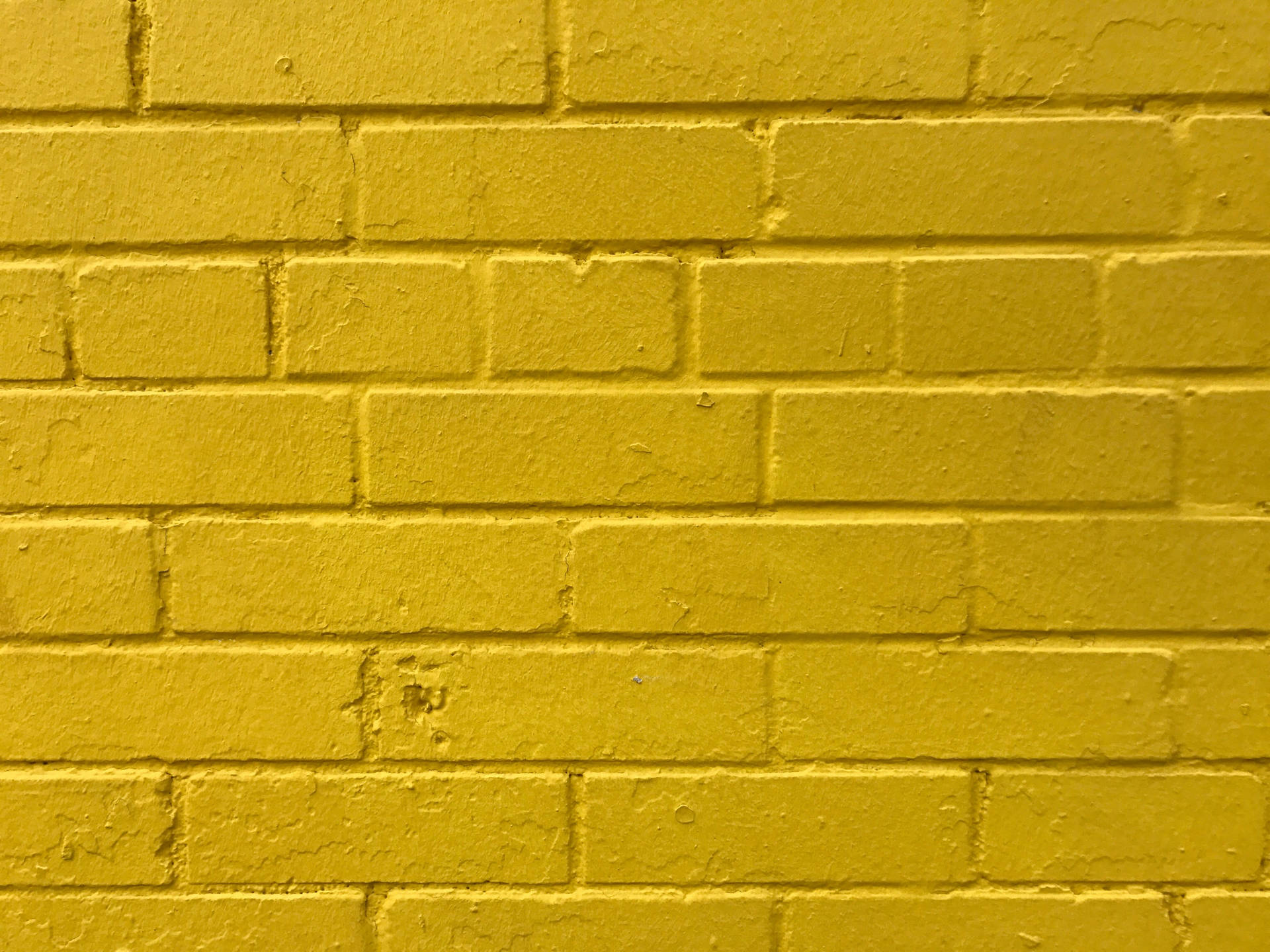 Caption: Radiant Golden Brick Wall Wallpaper
