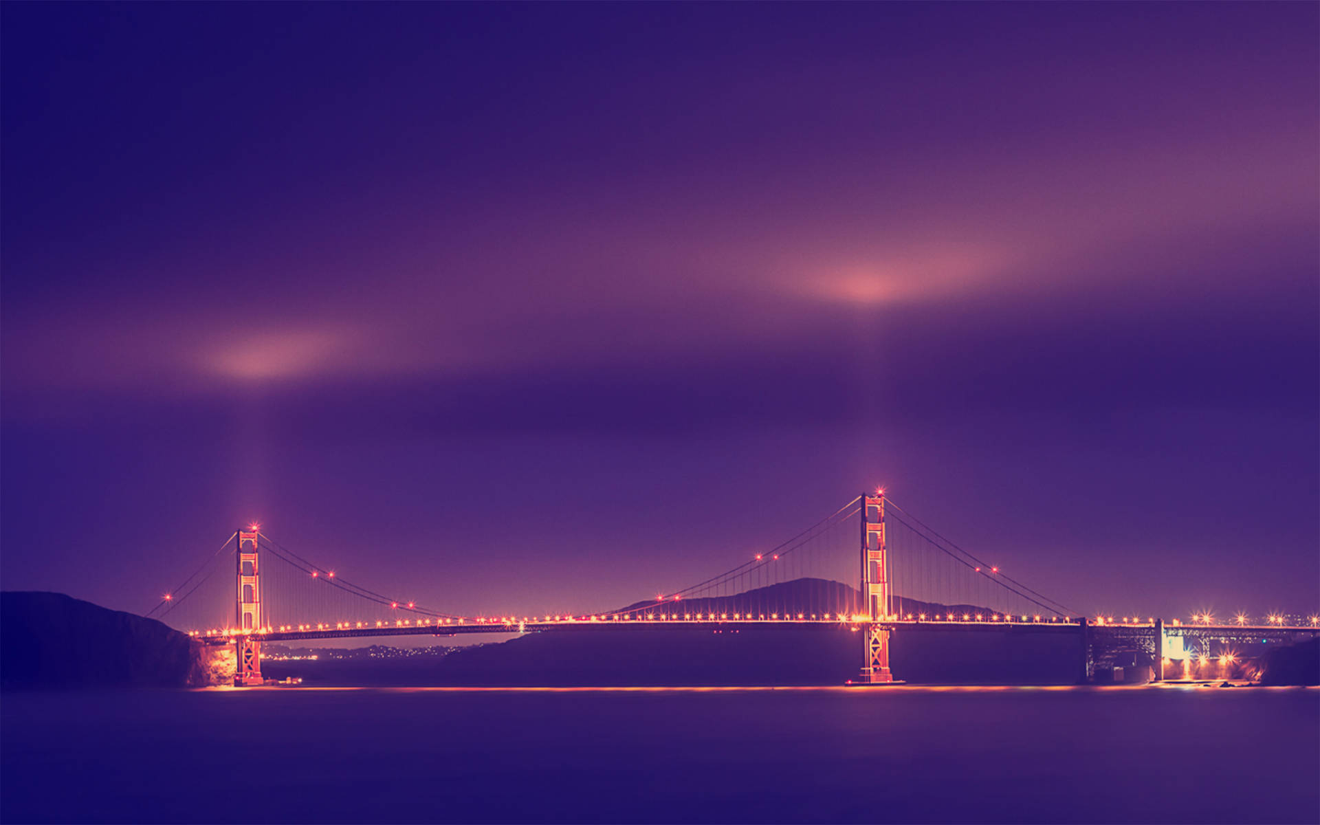 Vibrant Golden Gate Bridge Illuminated at Night Wallpaper