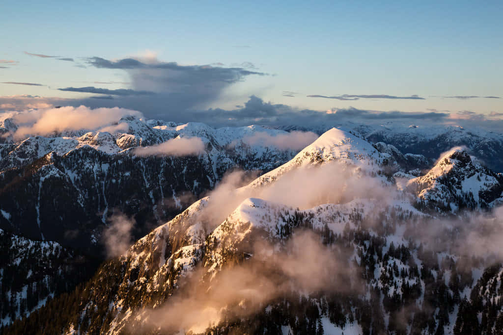 Golden Hour Over Snowy Mountains Wallpaper