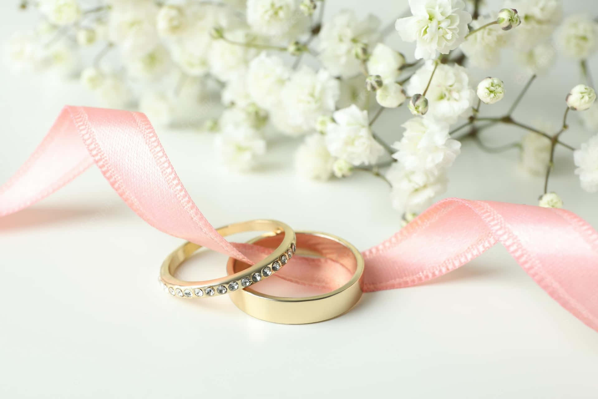 Golden Rings With Pink Ribbon Wedding Background Wallpaper