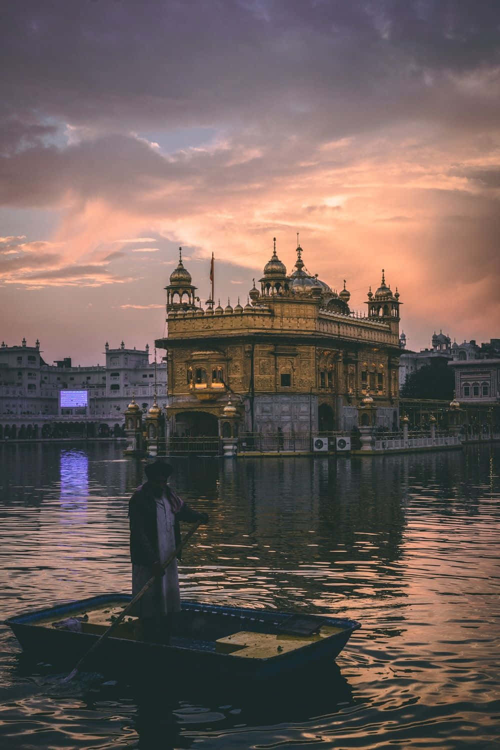 Majestic Golden Temple amid serene waters under a tranquil sky