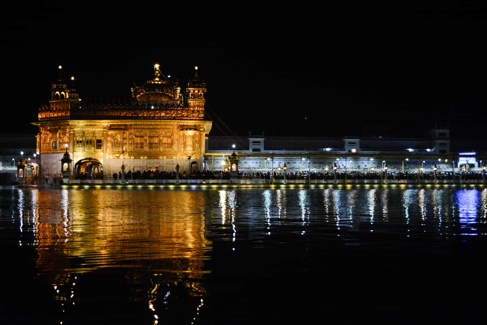 Majestic Golden Temple reflecting in serene water at dusk