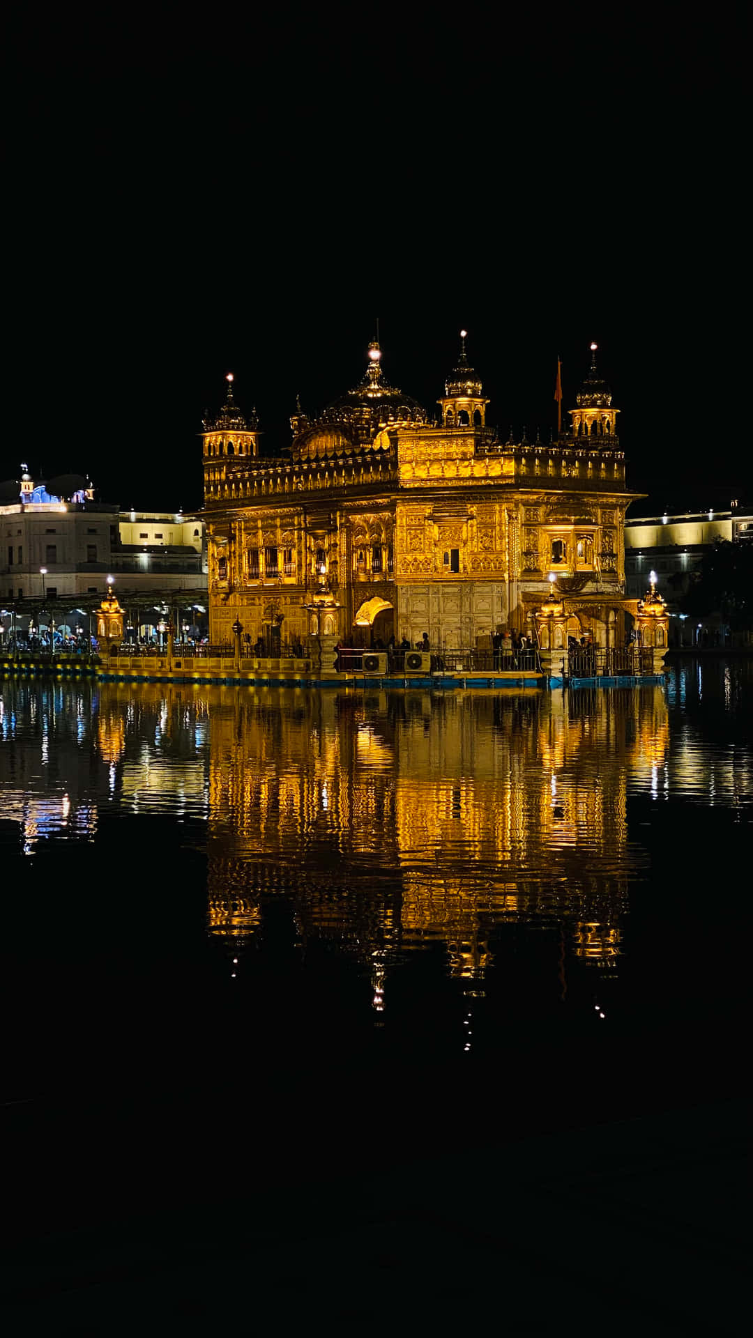 Golden Temple Lit Up At Night Wallpaper