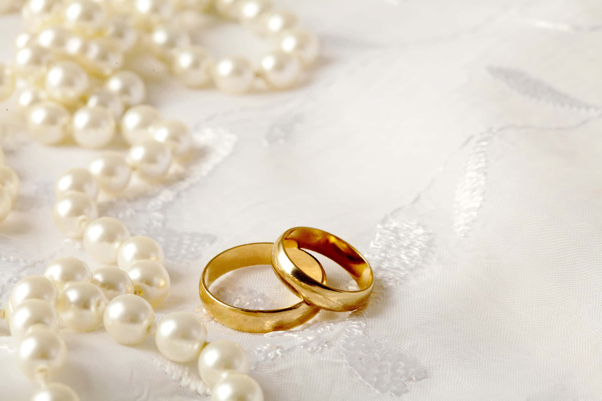 Golden Wedding Ring With Pearl Necklace Wallpaper