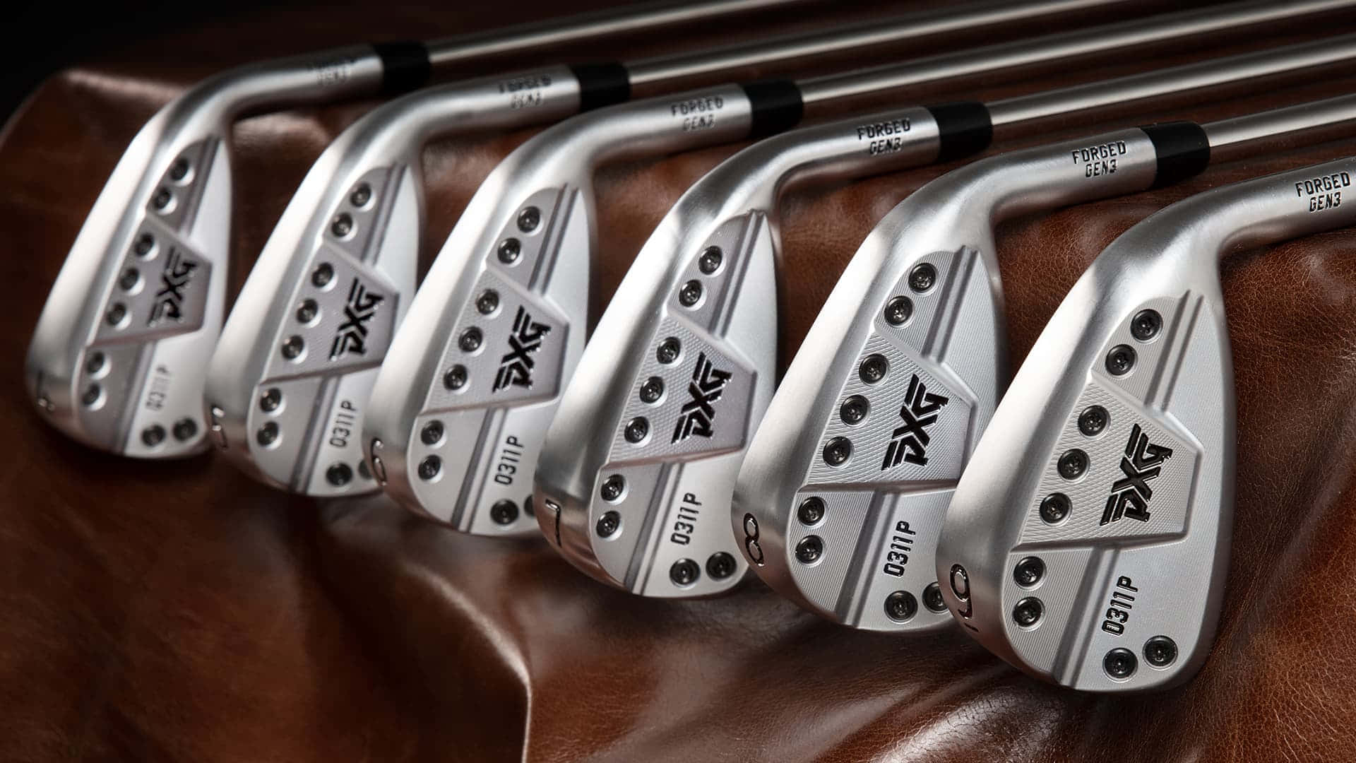 A Set Of Golf Irons On A Leather Couch