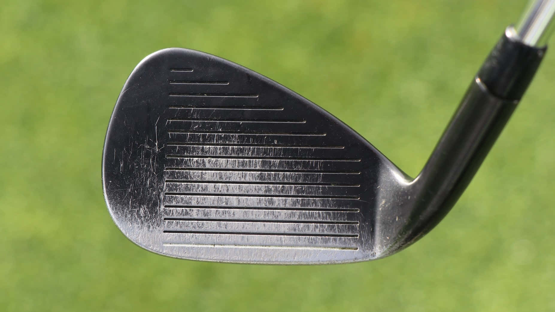 A Close Up Of A Golf Club With A Black Wedge