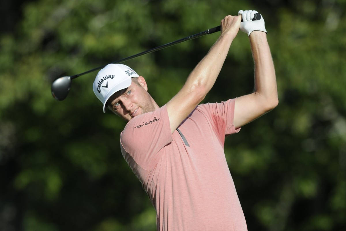 Golfer Chris Kirk svinger golfklub i et efterårsfelt Wallpaper