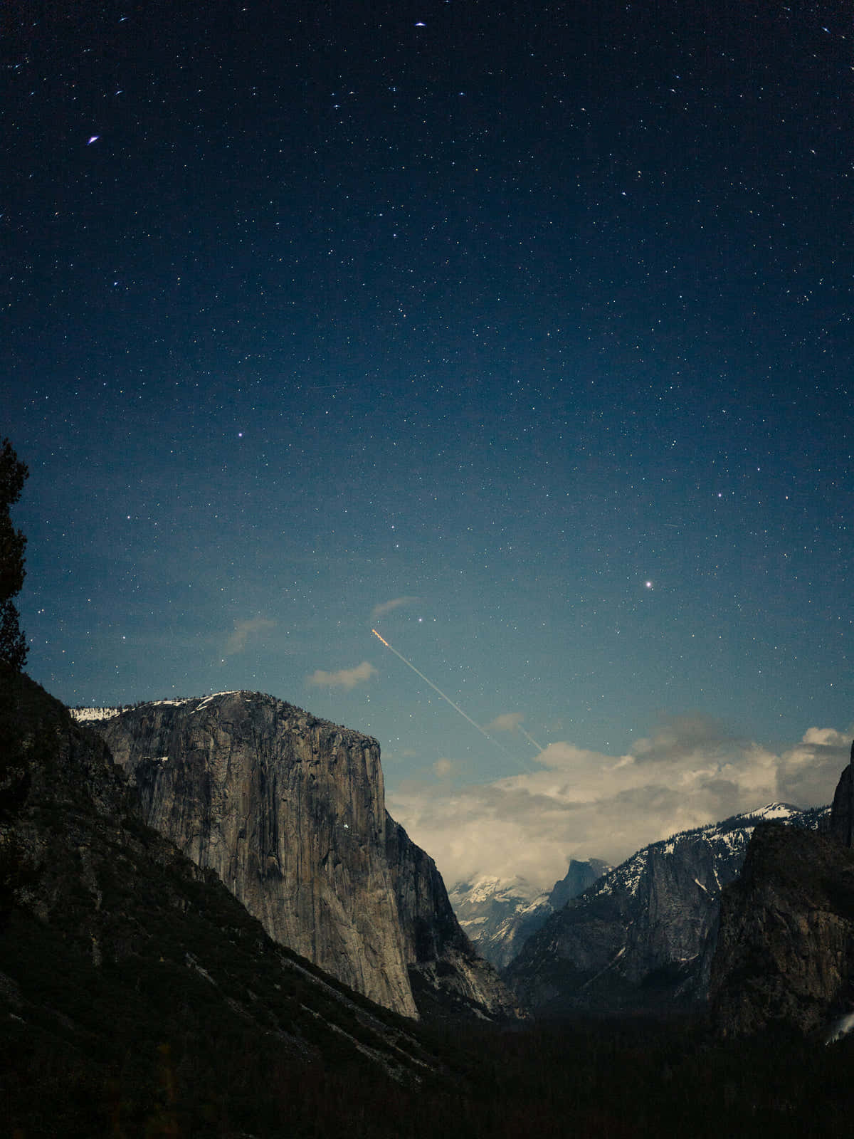 A Mountain Range With A Sky Full Of Stars