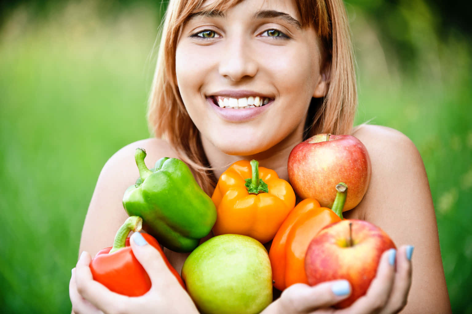 A Woman Holding A Bunch Of Fruits And Vegetables