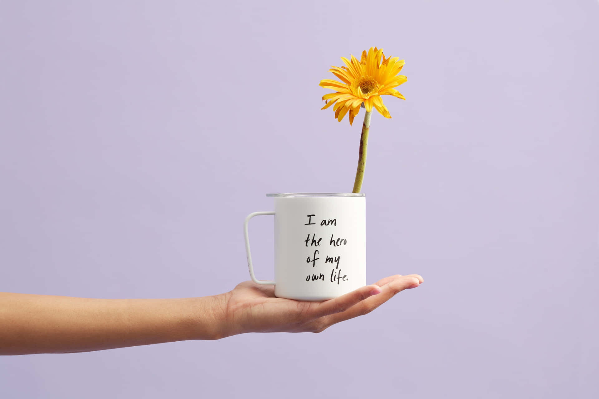 A Hand Holding A Mug With A Flower In It Wallpaper