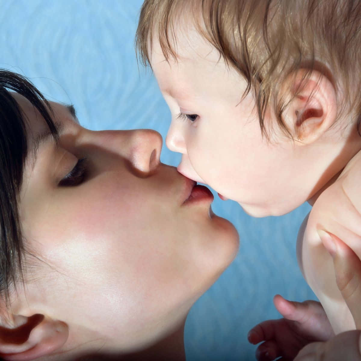 A Woman Kissing Her Baby