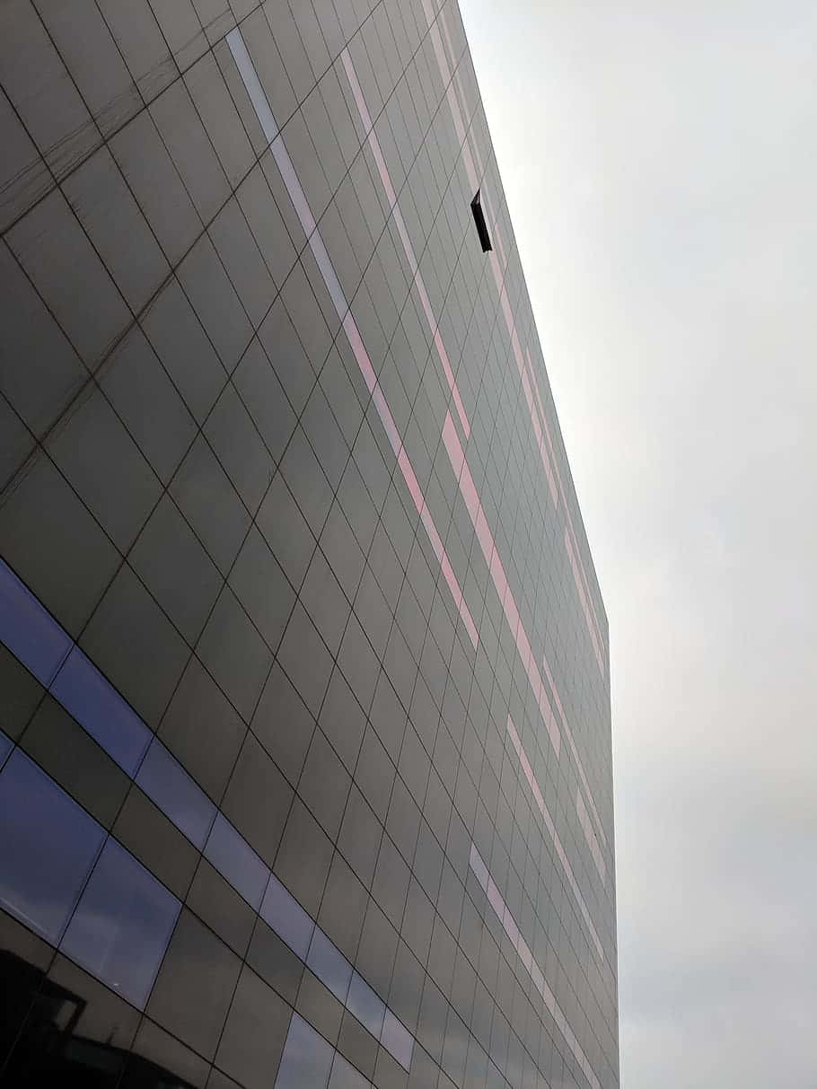 A Building With A Sky Blue Sky Wallpaper