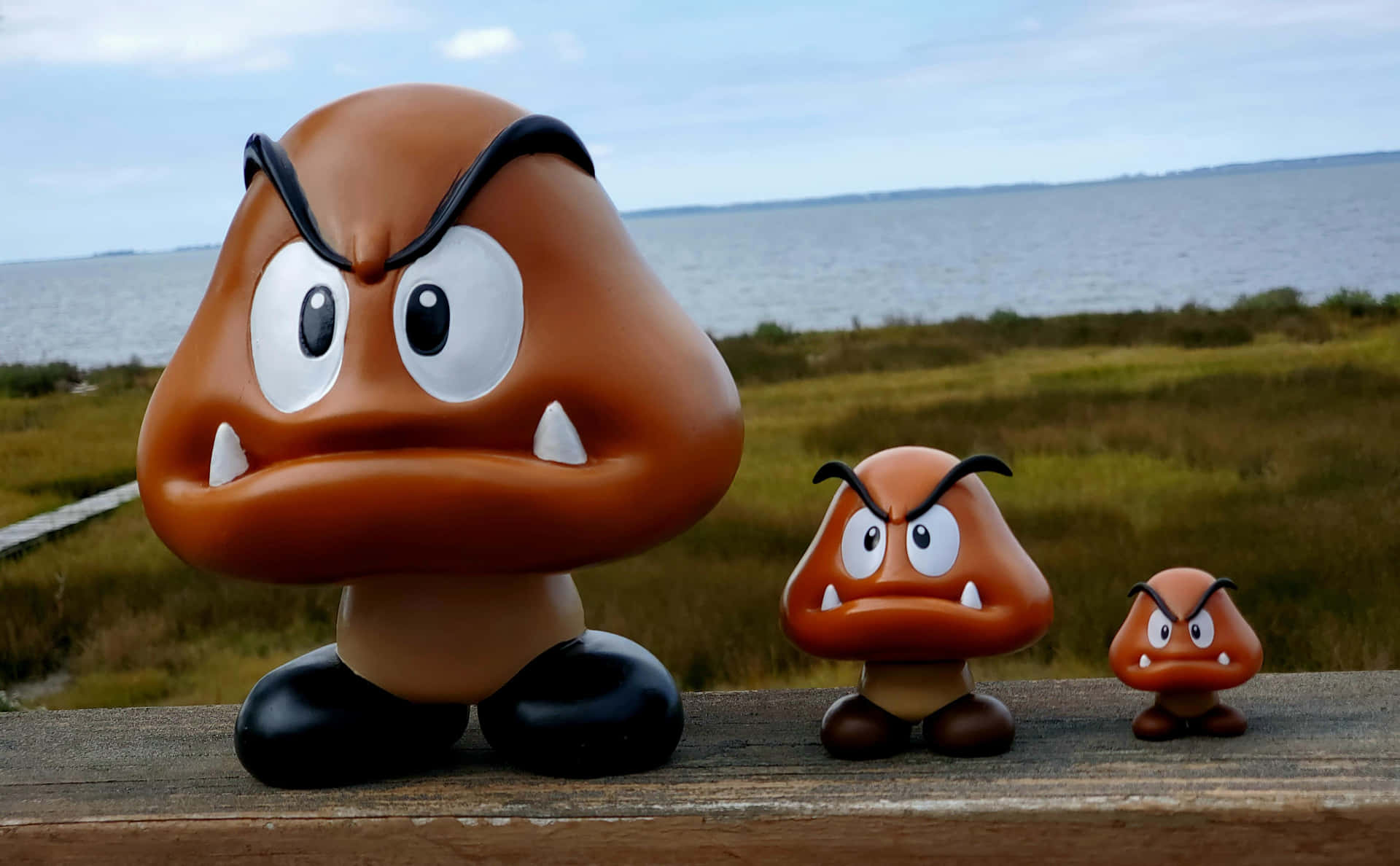 Goomba character posing in an action-packed scene Wallpaper