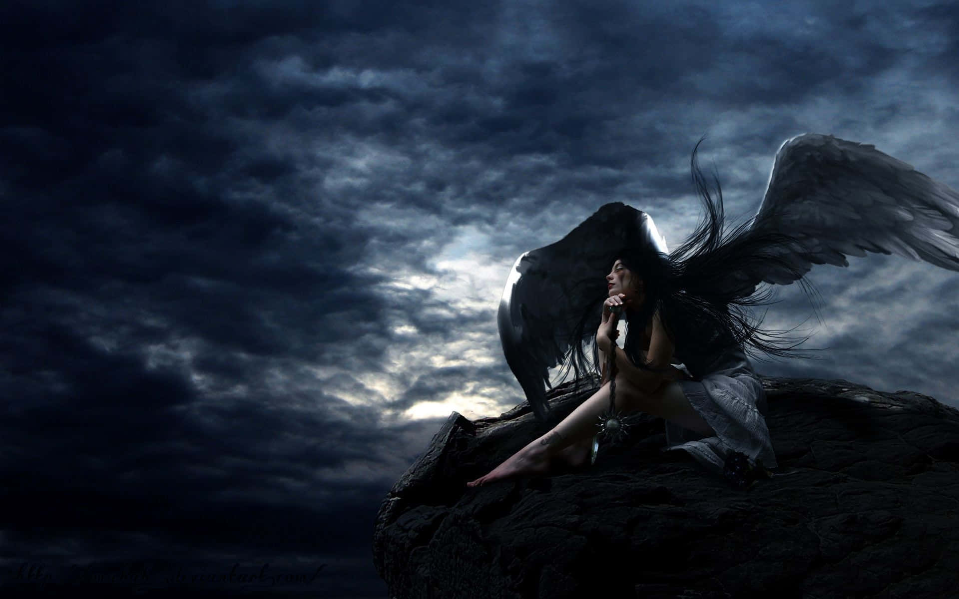 a woman sitting on a rock with wings