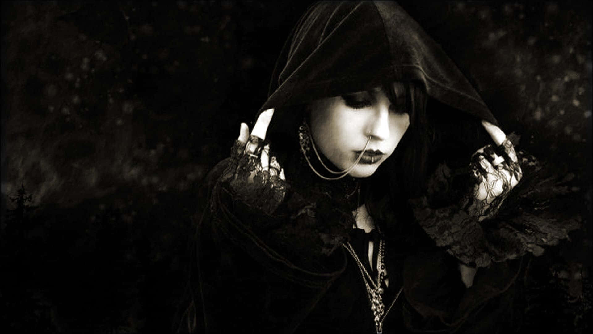 A Woman In Black With A Hood And A Necklace