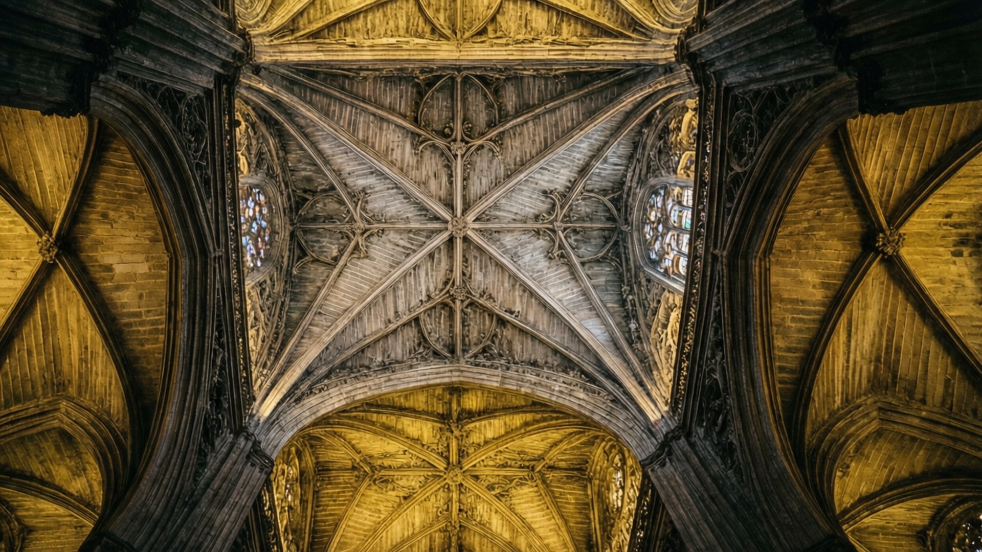Worm's-eye view of Gothic ceiling inside Seville Cathedral.