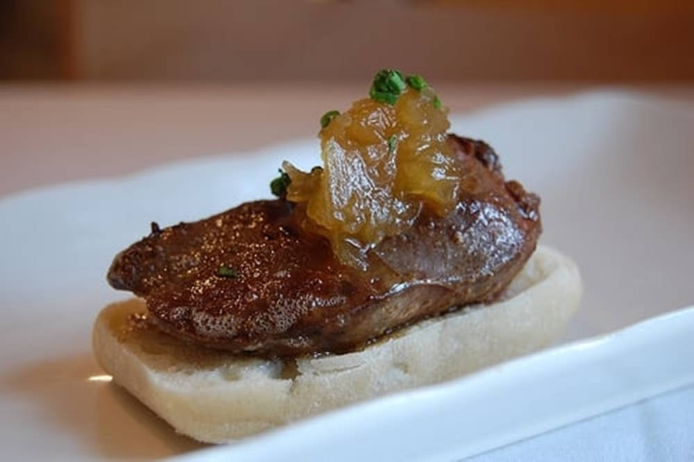 Gourmet Liver Dish Garnished with Caramelized Onions Wallpaper
