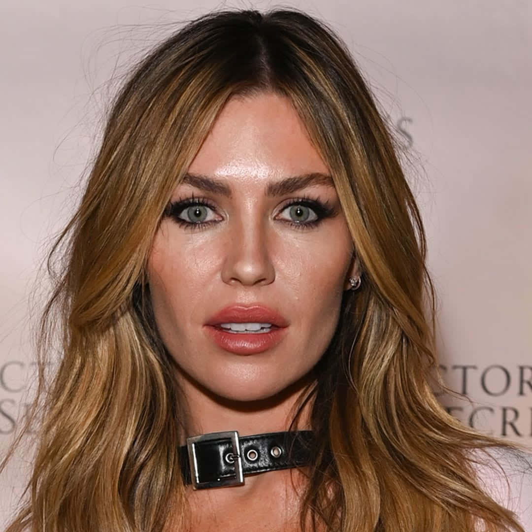 Graceful Abbey Clancy Poses In A Stunning Black Dress Wallpaper