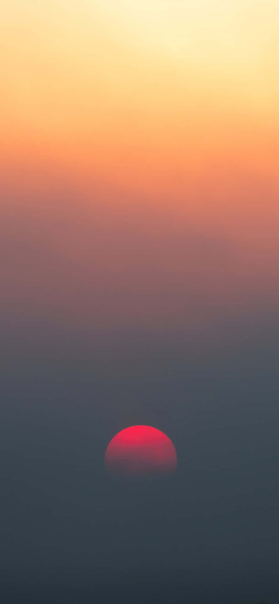 A Red Sun Rising Over A Fog Filled Sky Wallpaper