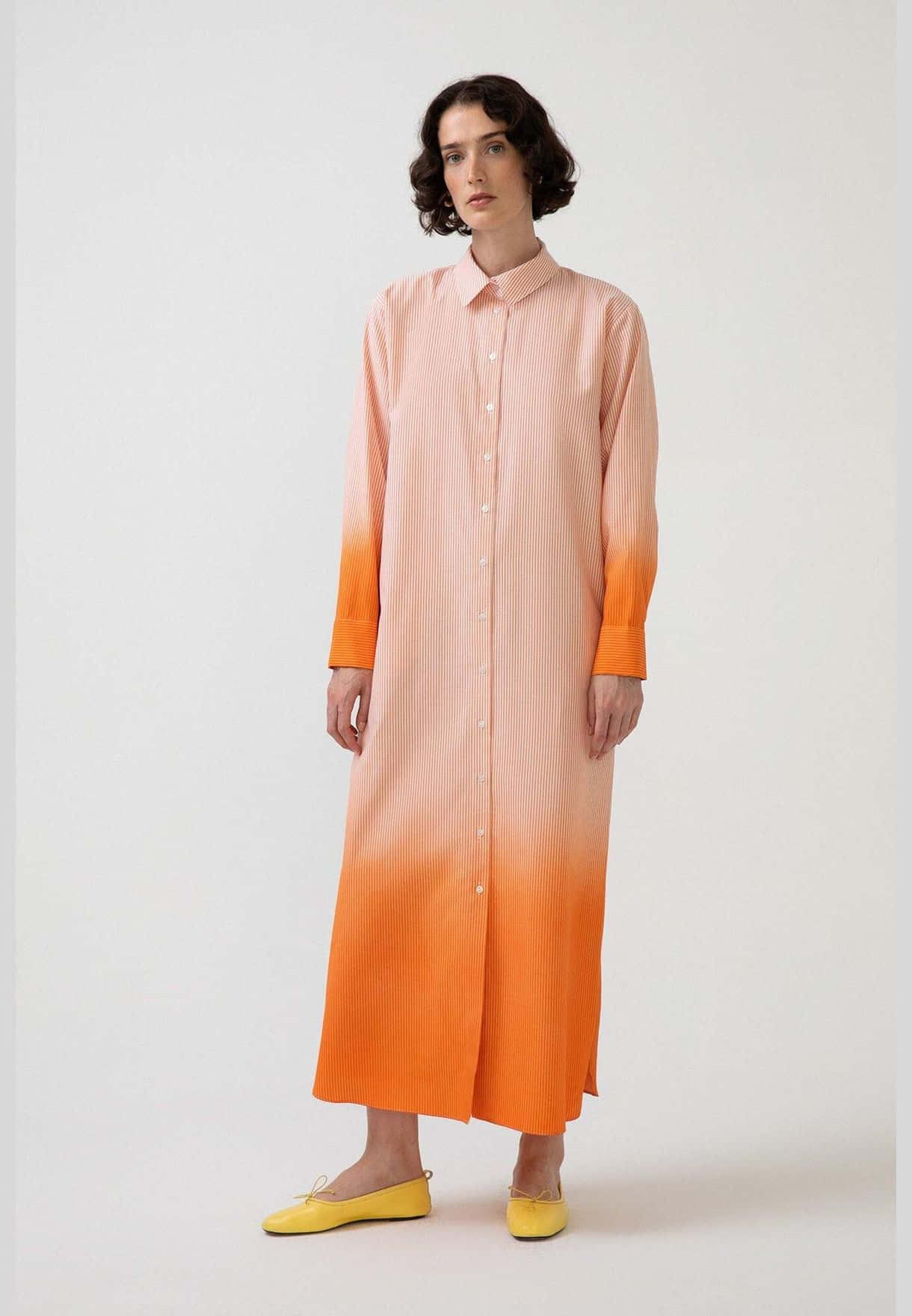 Enkvinna Iförd En Skjortklänning I Orange Och Gult.