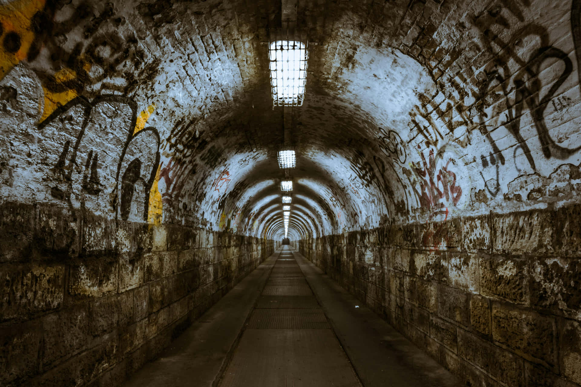 Graffiti Adorned Tunnel With Lights Wallpaper