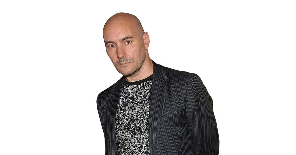 Grant Morrison, renowned comic book writer and creator, delivering a speech during an event. Wallpaper
