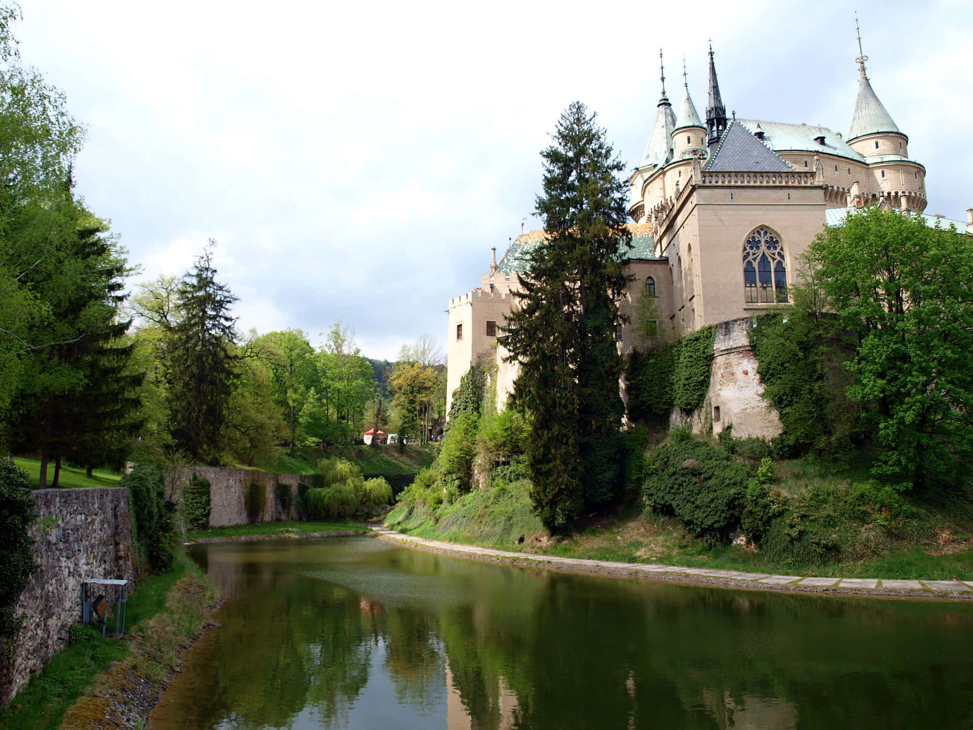 Majestic Bojnice Castle Amidst Verdant Greenery Wallpaper
