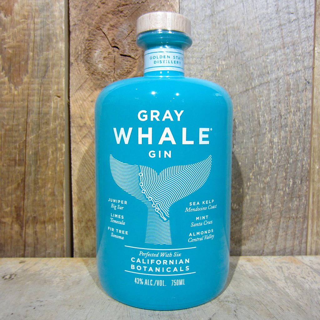 A bottle of Gray Whale Gin set against a wooden backdrop Wallpaper