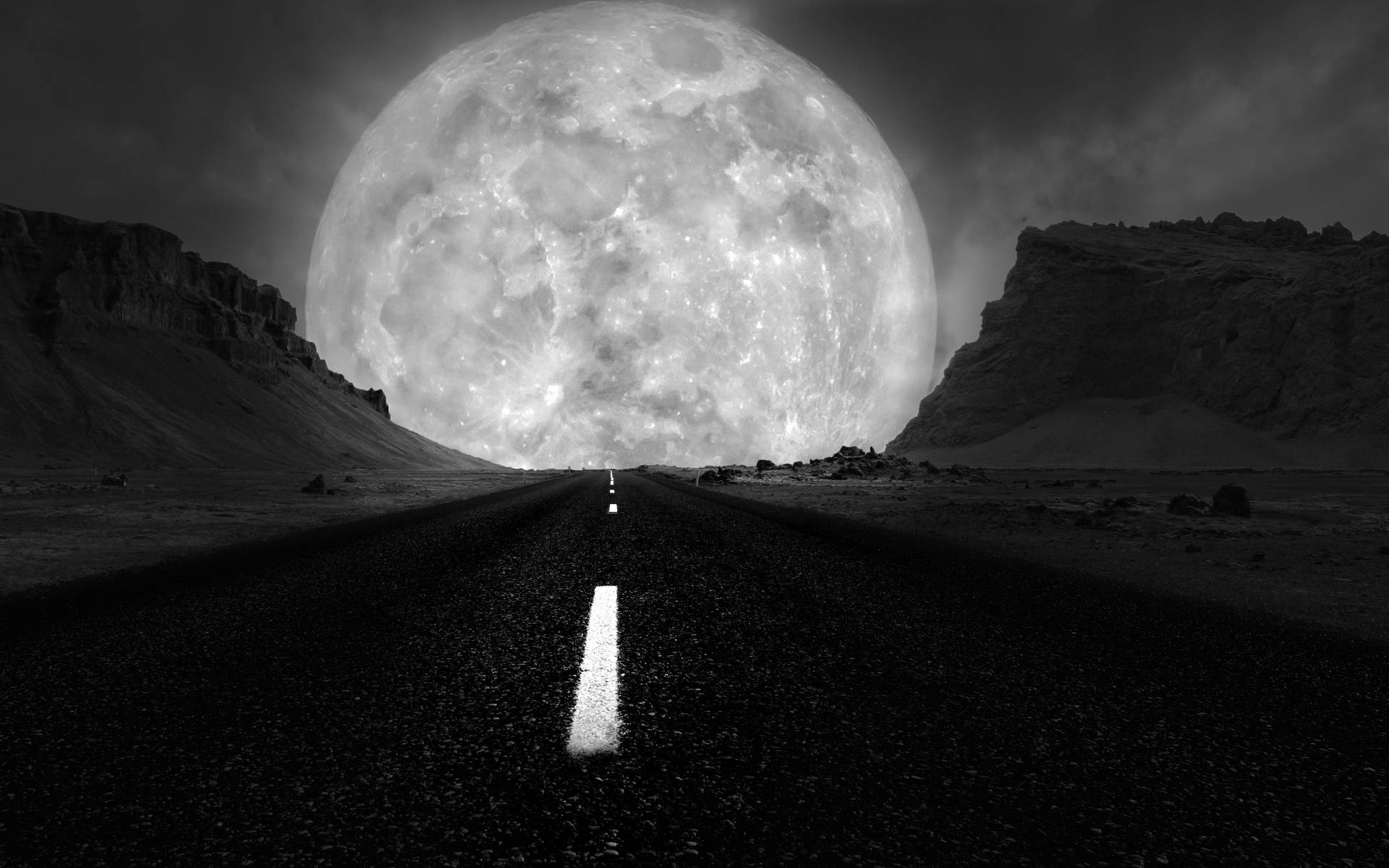 A Striking Image of the Grayscale Galaxy Moon Over a Lonely Road Wallpaper