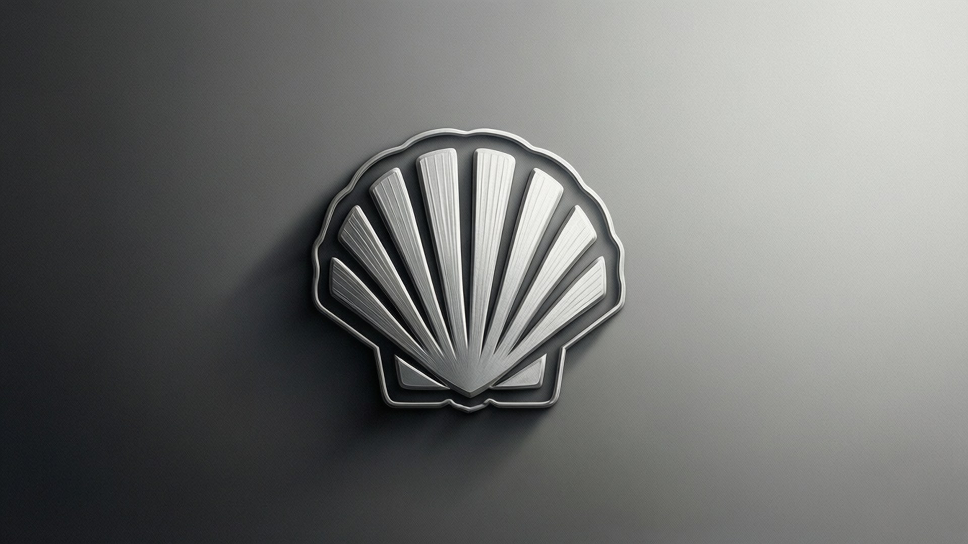 Monochrome Shell logo with silver gradient.