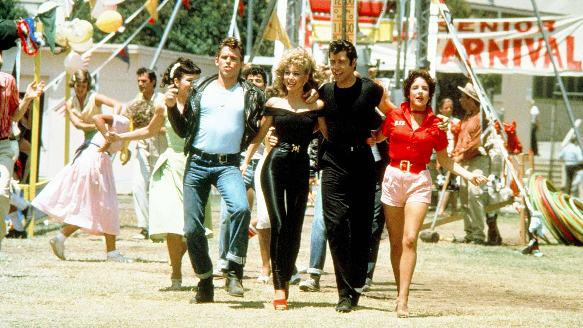 Grease Characters Walking At Carnival Background