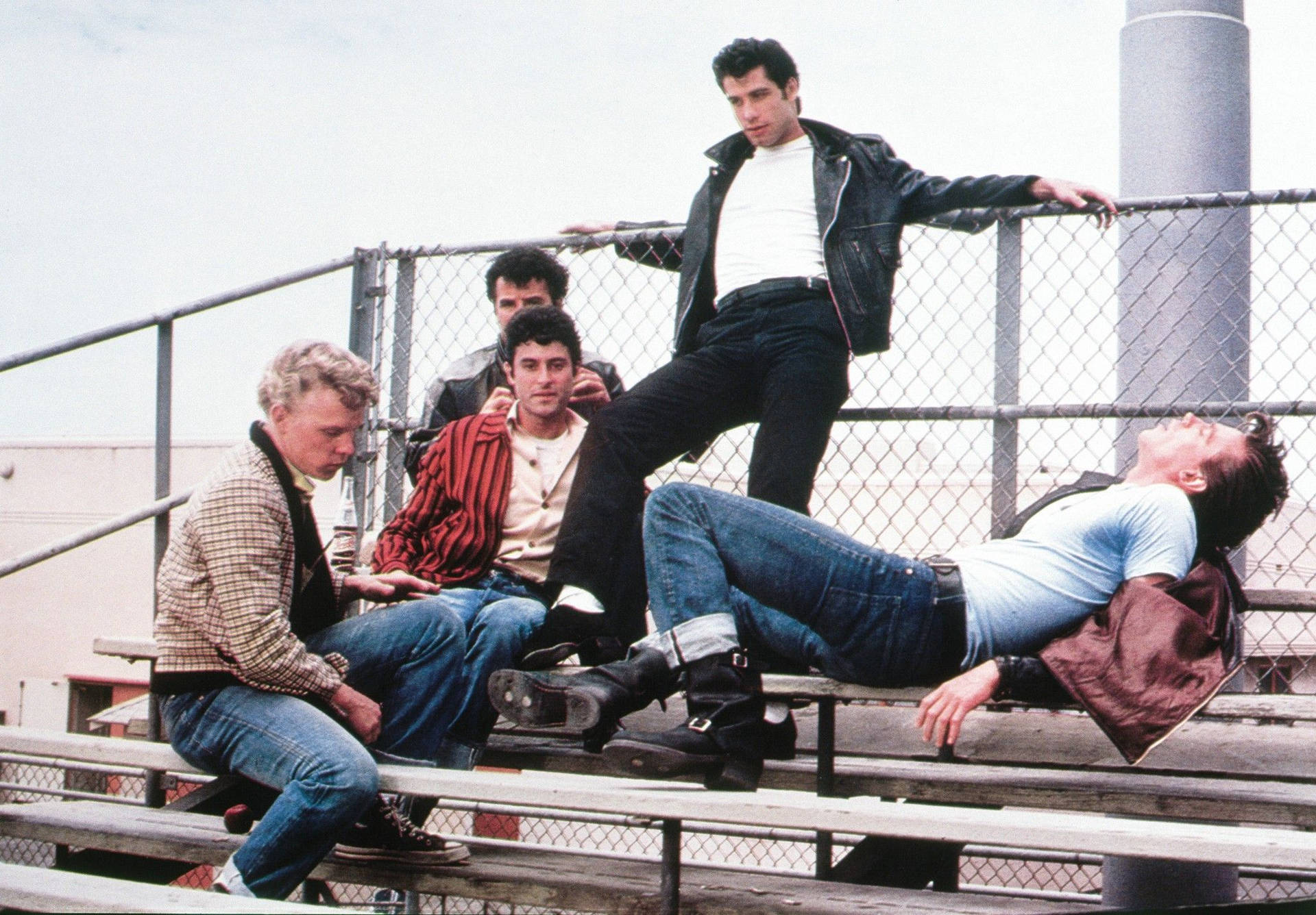 Grease Male Characters In Bleachers Background