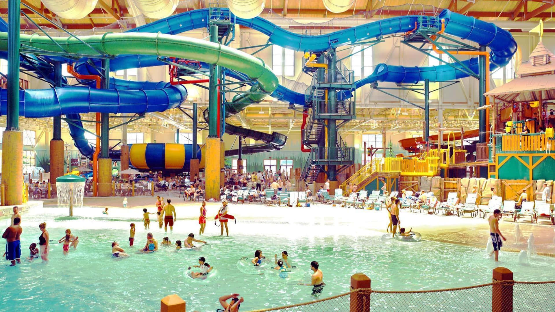 A Large Indoor Water Park With Many People Playing