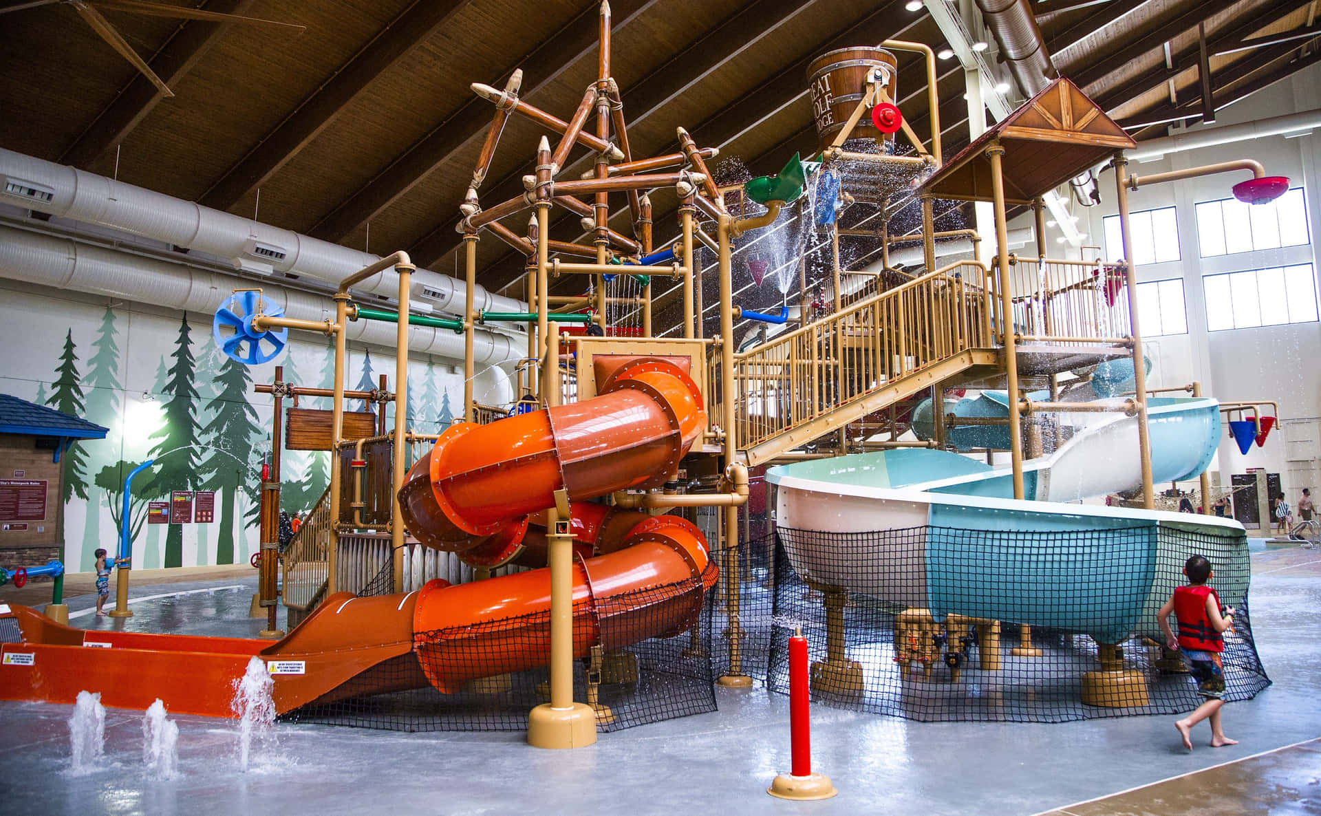 A Large Indoor Water Park With A Slide
