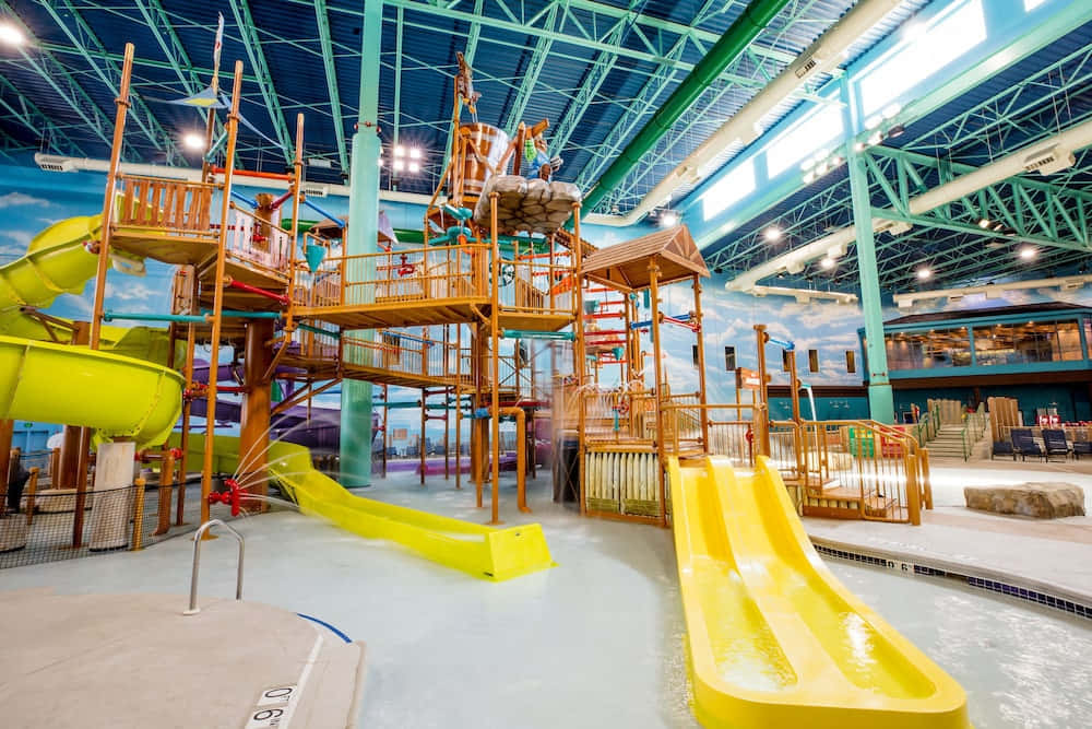A Large Indoor Water Park With A Slide And Water Slide