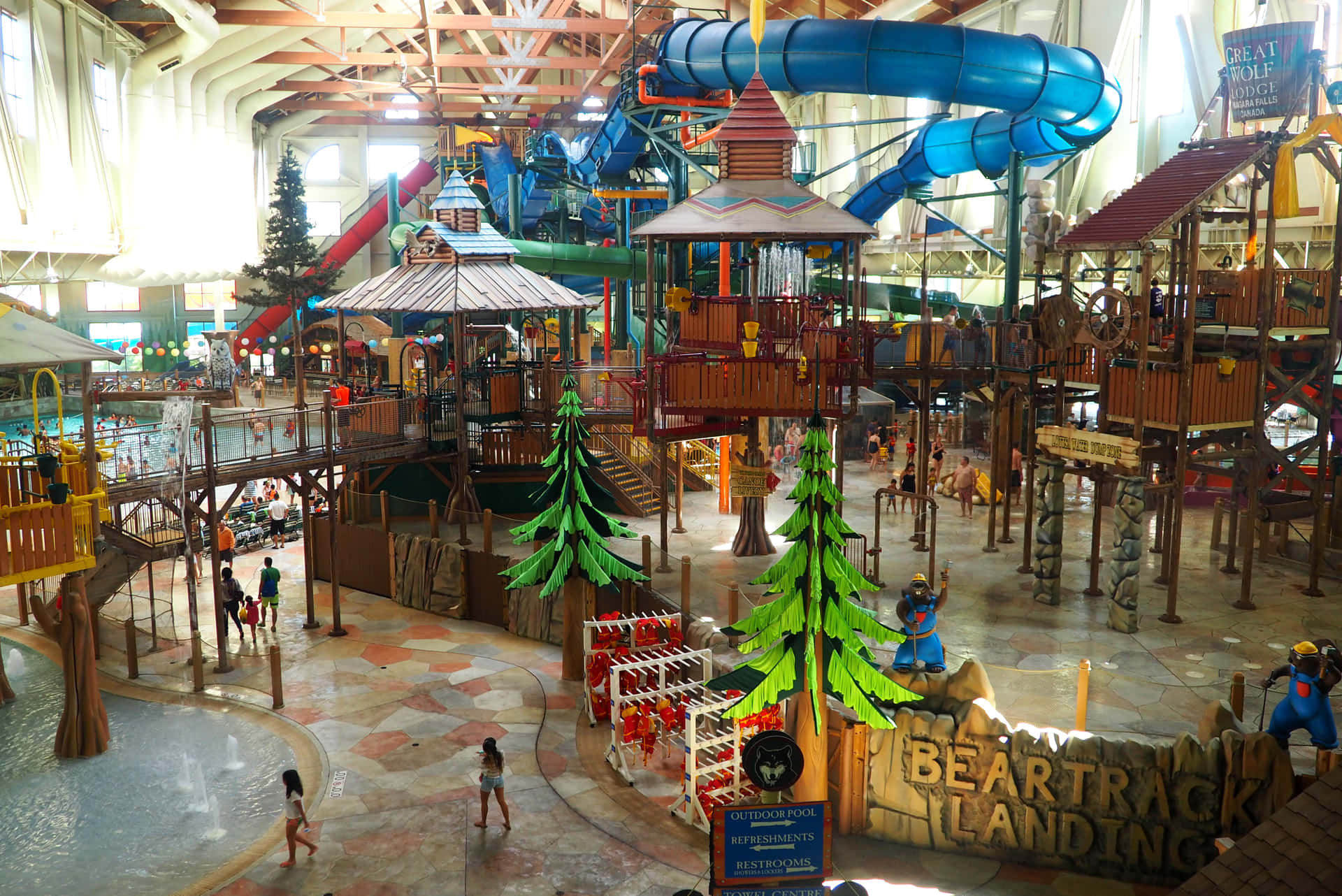 A Large Indoor Water Park With Many Slides And Water Slides