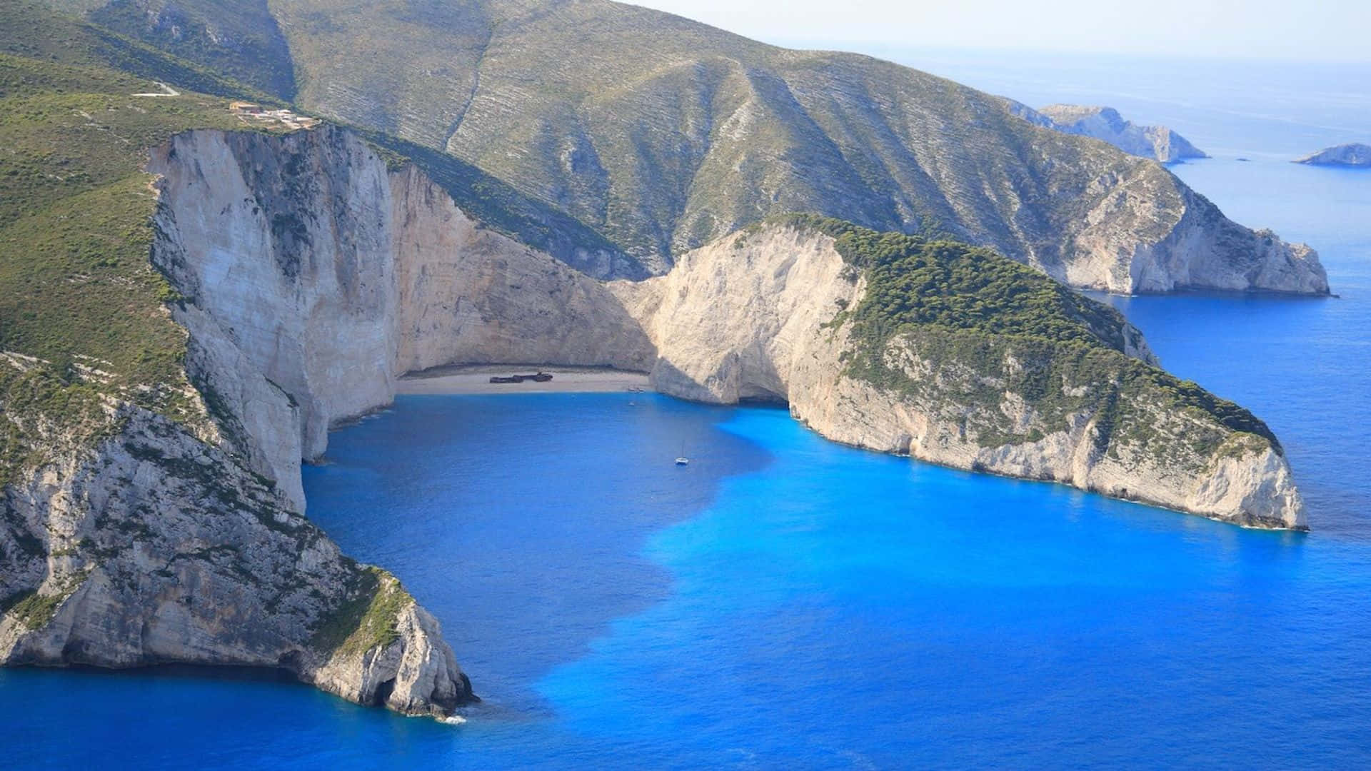 Serene Greek Beach - A Relaxing Paradise Wallpaper