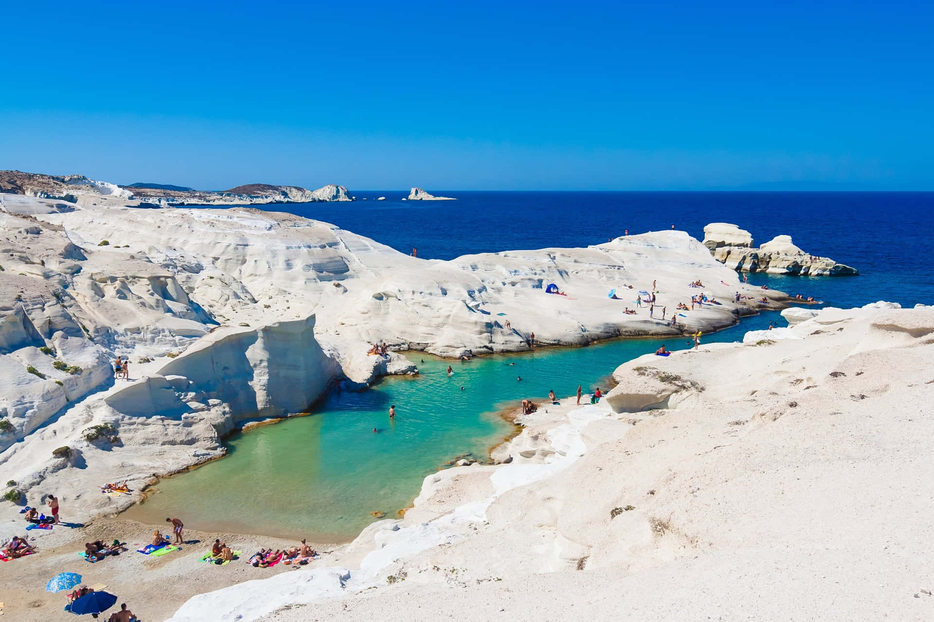 Serene Greek Beach Overlooking Crystal Clear Waters Wallpaper