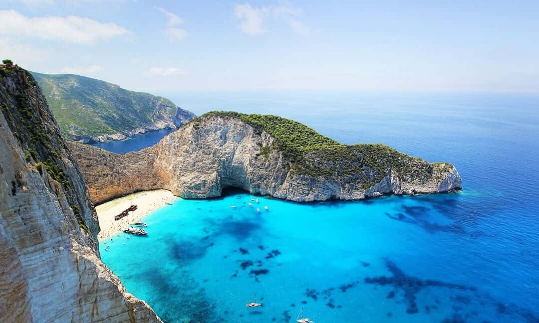 Astonishing view of a crystal-clear turquoise bay on a dreamy Greek Island Wallpaper