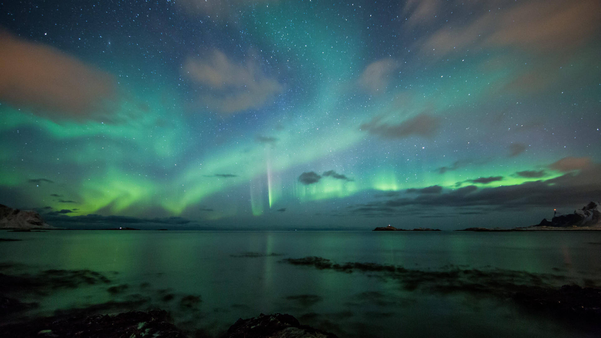 Marvel at the beauty of the Green Aurora Borealis in the night sky Wallpaper