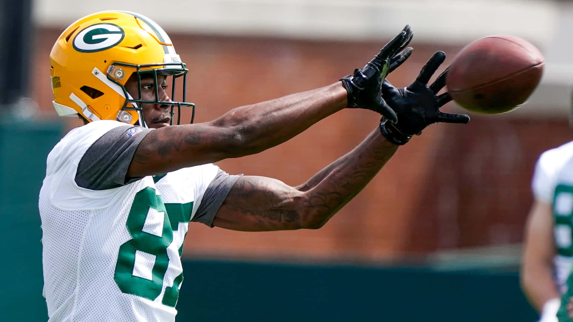 Green Bay Receiver Catching Football Practice Wallpaper