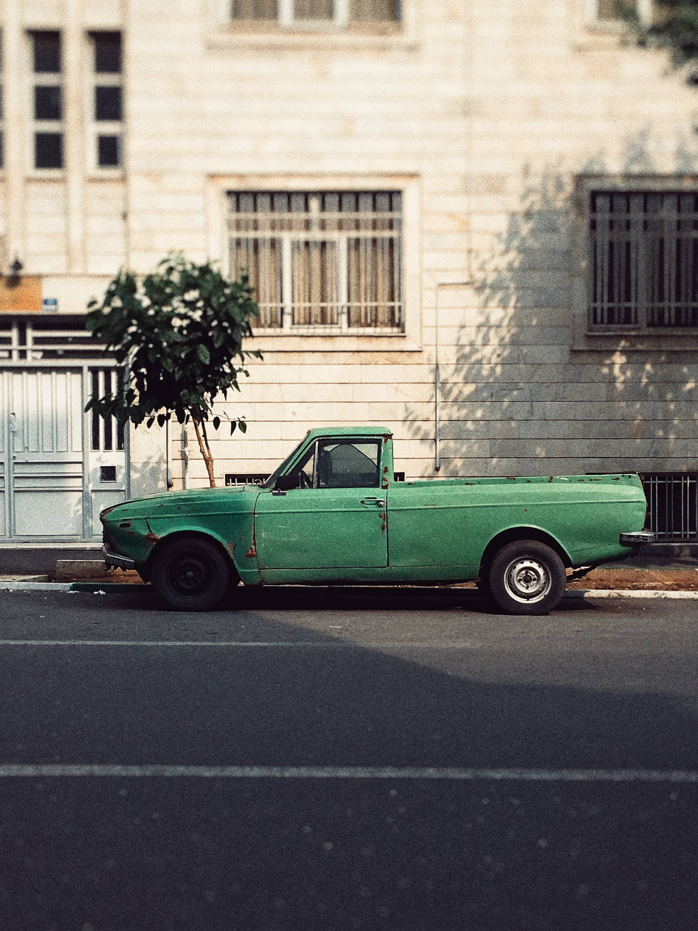 Green Car In The Street Wallpaper