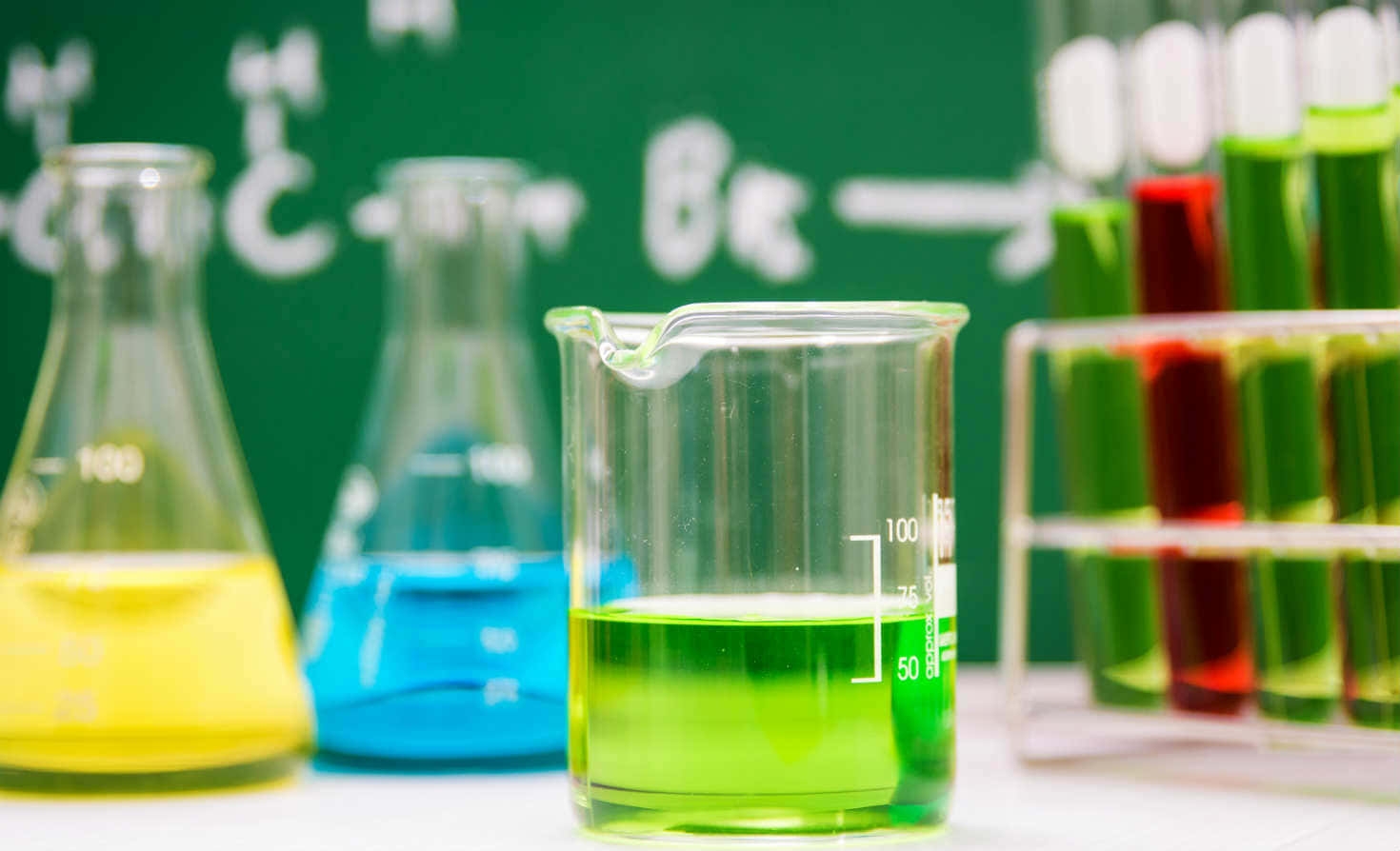 Green chemistry lab with glassware and fresh plants Wallpaper