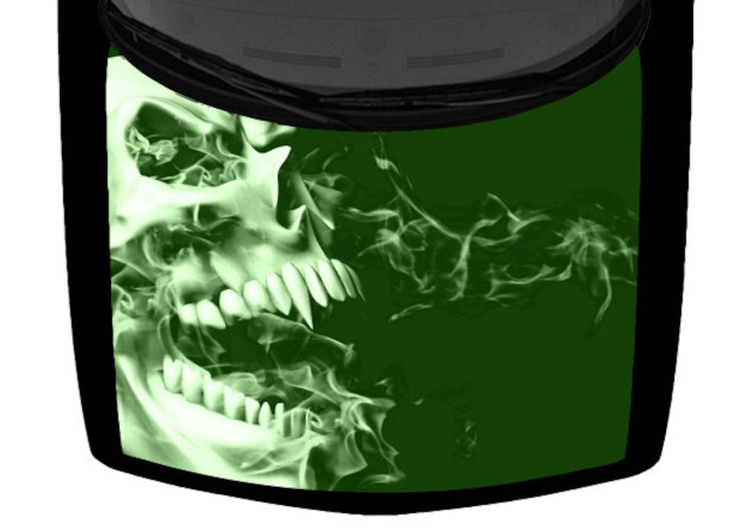 A menacing green skull sits atop a burning flame Wallpaper