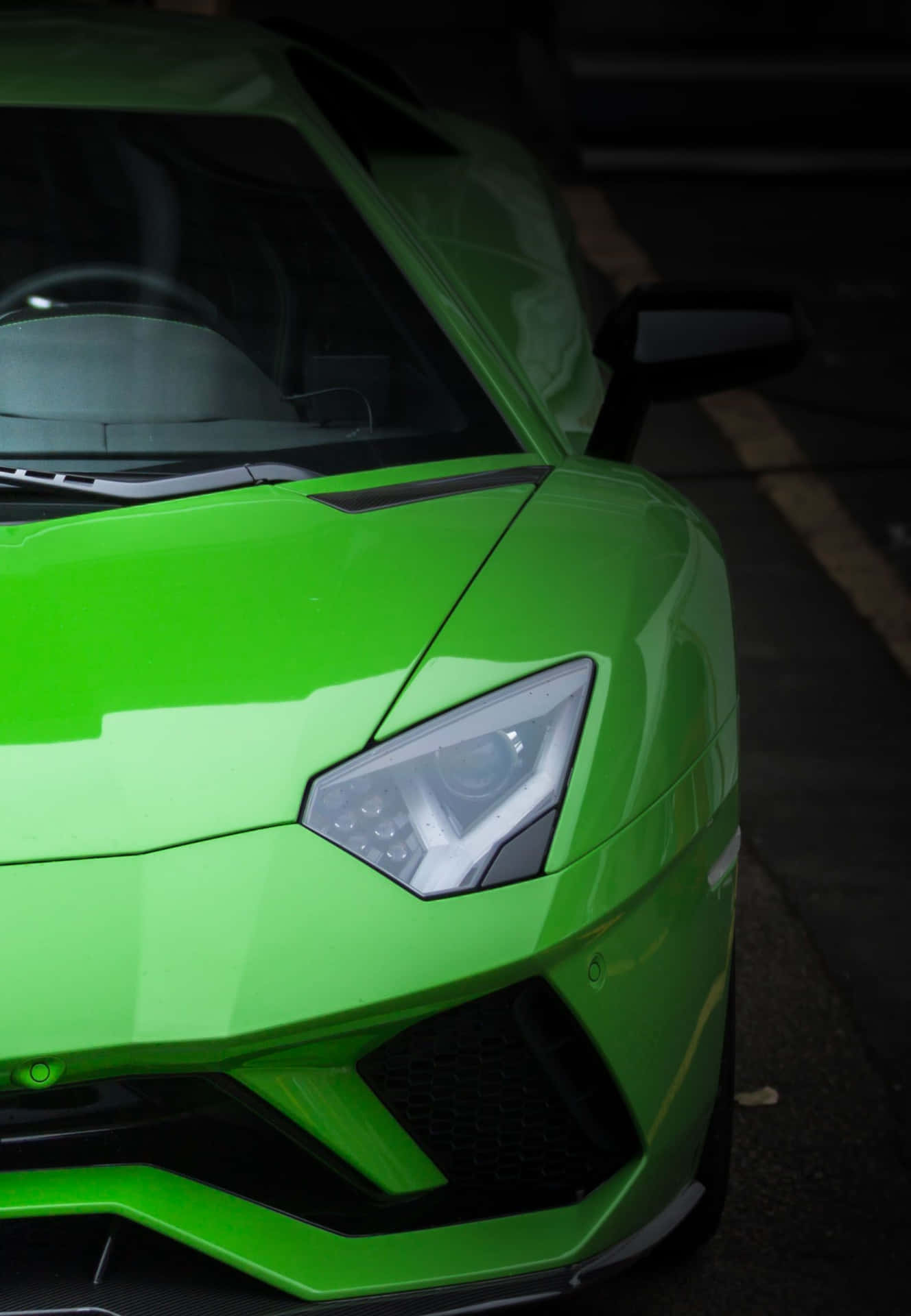 Zoom into luxury: An up close look of a green Lamborghini. Wallpaper