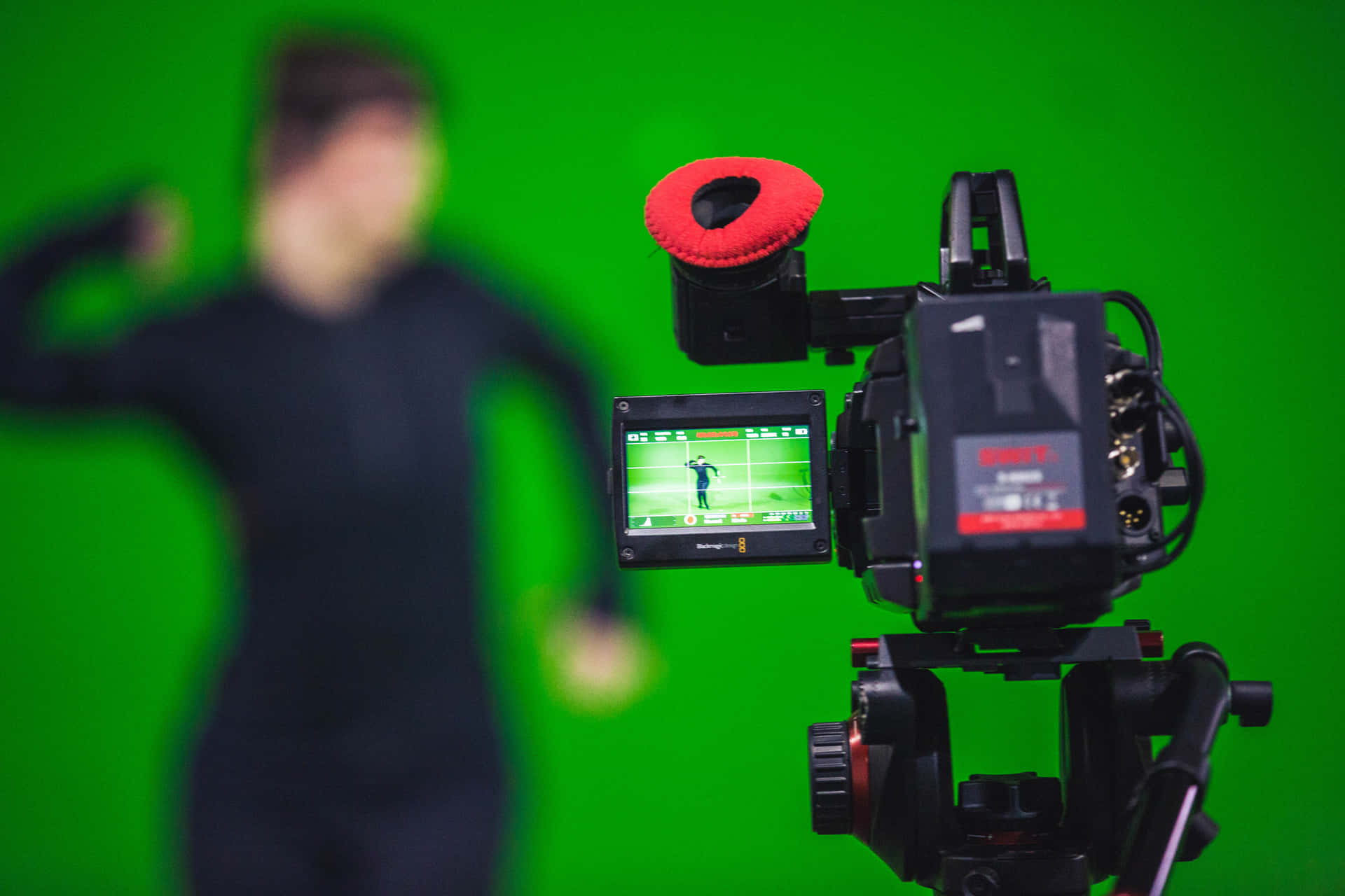A Woman Is Standing In Front Of A Green Screen