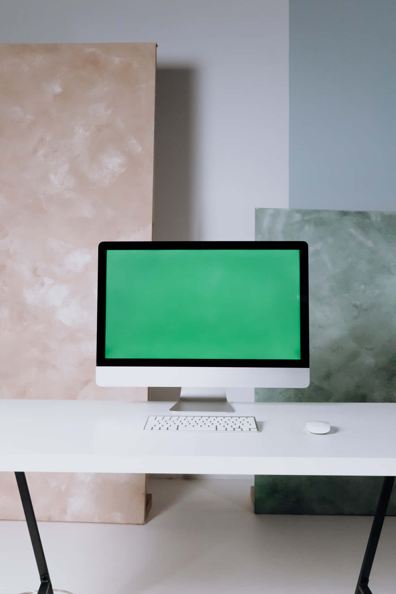A White Desk With A Green Screen And A White Chair