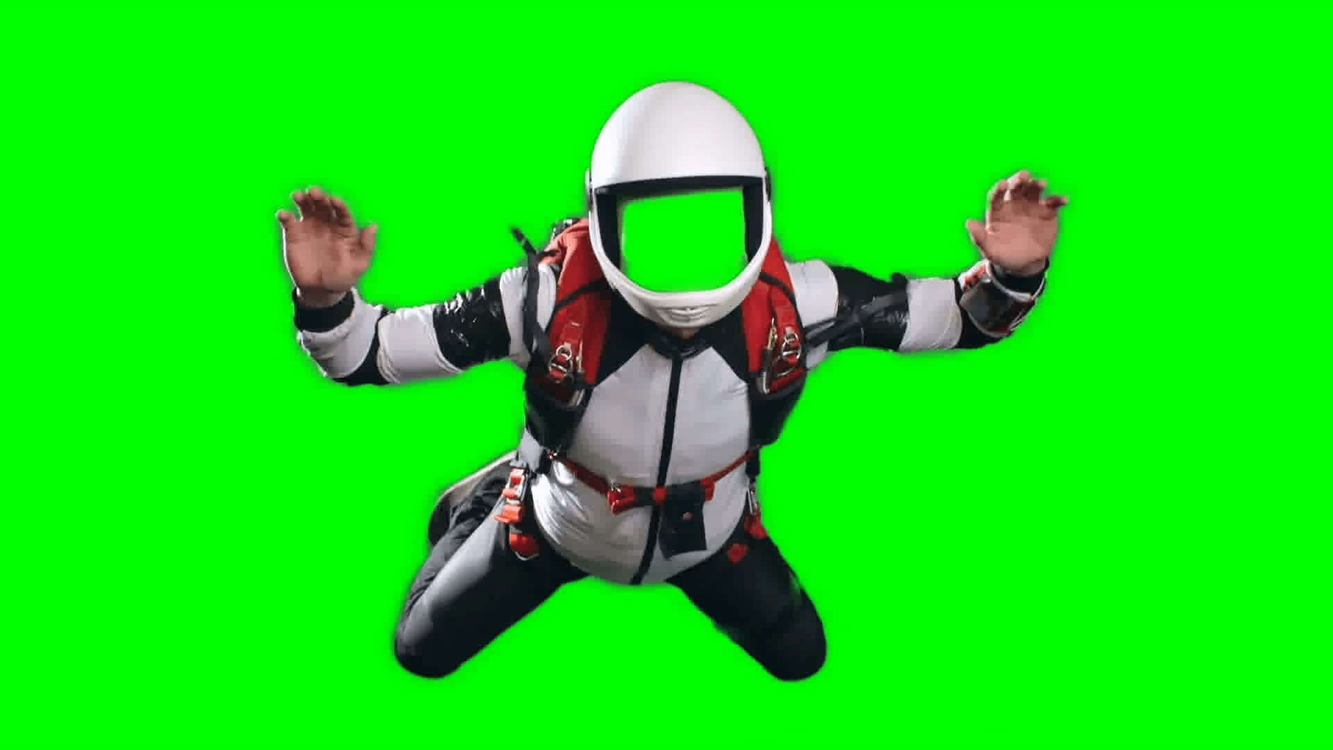 a man in a helmet is jumping on a green screen