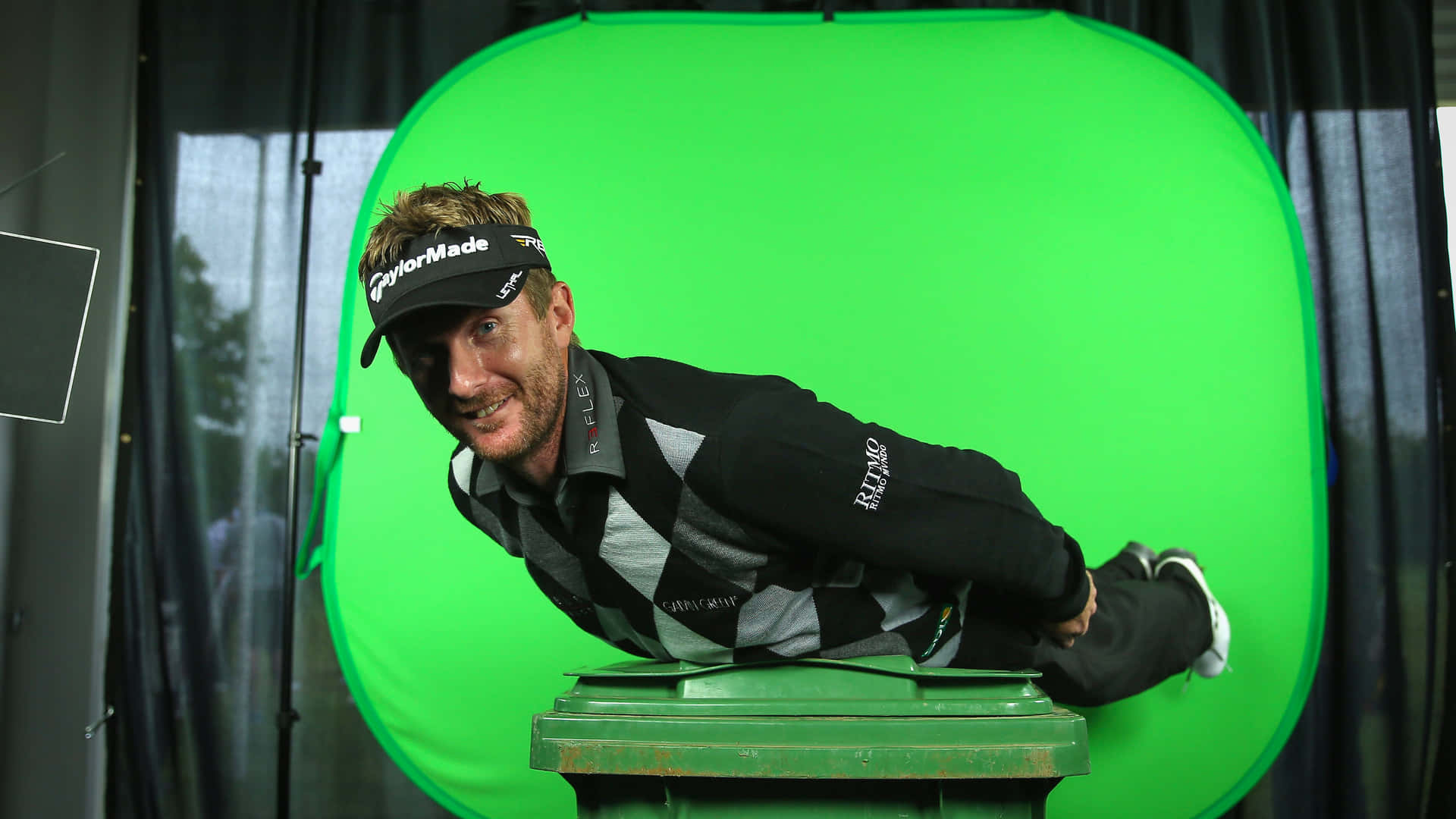 a man is laying on a green screen