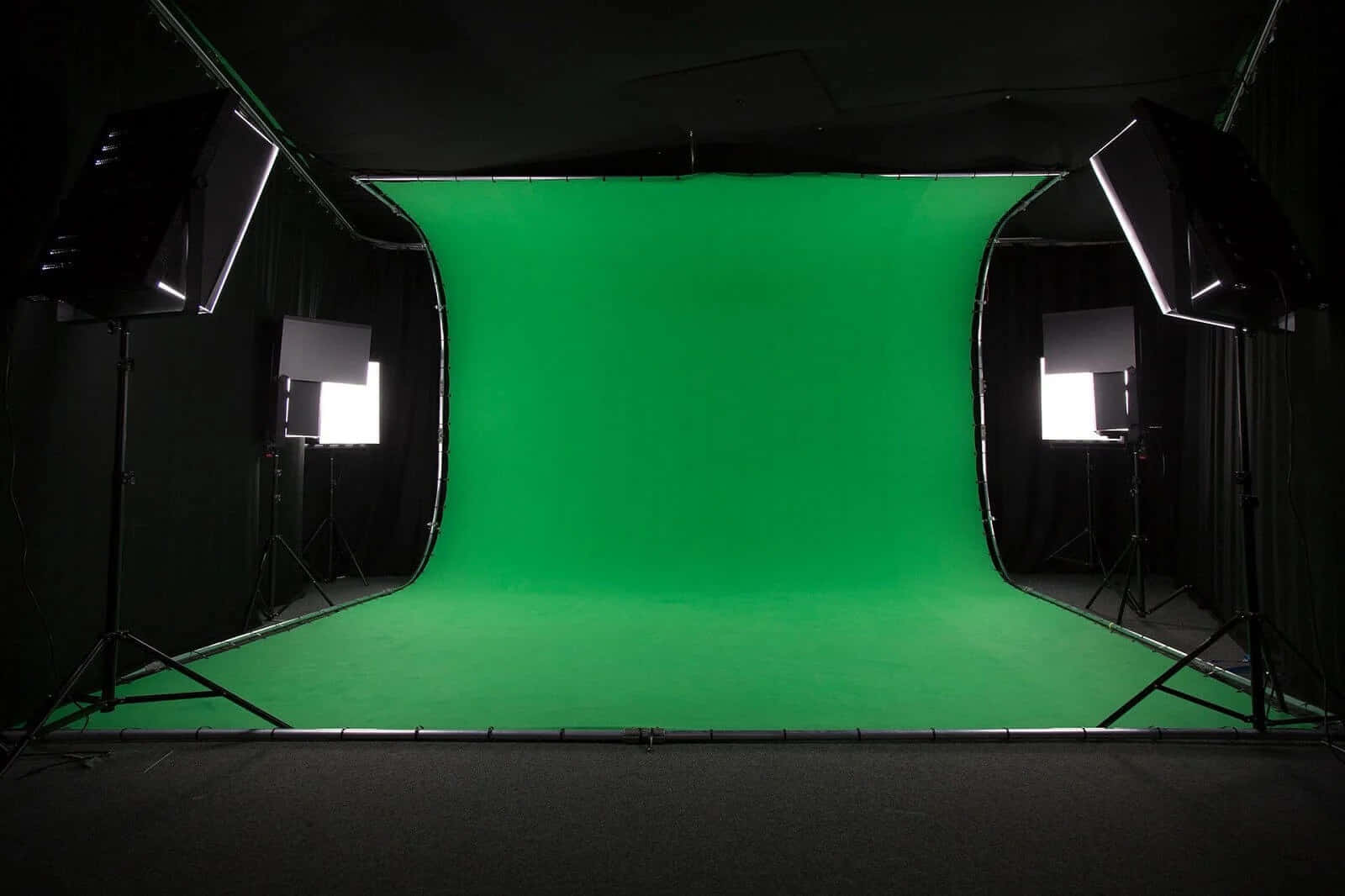 a green screen studio with lights and a green screen